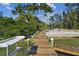 Wooden walkway leading to the water, providing convenient access for boating at 7147 La Lenaire Dr, Longboat Key, FL 34228