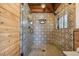 Walk-in shower with patterned tile and glass enclosure at 7147 La Lenaire Dr, Longboat Key, FL 34228