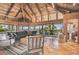 Spacious living area with vaulted wood ceilings, comfy seating and access to balcony at 7147 La Lenaire Dr, Longboat Key, FL 34228