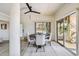 Bright dining room with round table and chairs, access to patio and pool views at 7147 La Lenaire Dr, Longboat Key, FL 34228
