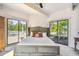 Main bedroom with king-size bed and access to private deck at 7147 La Lenaire Dr, Longboat Key, FL 34228