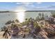 Aerial view of waterfront home with private dock and lush landscaping at 7147 La Lenaire Dr, Longboat Key, FL 34228
