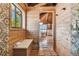 Bathroom with a shower and built-in bench, with views into the main bathroom area at 7147 La Lenaire Dr, Longboat Key, FL 34228