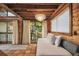 Relaxing bedroom with tiled floors, daybed, and access to a private balcony at 7147 La Lenaire Dr, Longboat Key, FL 34228