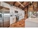 Modern kitchen featuring white cabinets, stainless steel appliances, and terracotta tile floors at 7147 La Lenaire Dr, Longboat Key, FL 34228