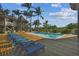 Relaxing pool area with lounge chairs and waterfront views at 7147 La Lenaire Dr, Longboat Key, FL 34228