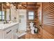 Modern bathroom with white cabinets, walk-in shower, and tile floors at 7147 La Lenaire Dr, Longboat Key, FL 34228