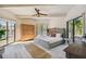 Main bedroom with king-size bed, and large windows with nature views at 7147 La Lenaire Dr, Longboat Key, FL 34228