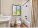 Clean bathroom with a bathtub, toilet, and updated vanity at 7147 La Lenaire Dr, Longboat Key, FL 34228