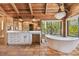 Luxury bathroom with a soaking tub, double vanities, and water views at 7147 La Lenaire Dr, Longboat Key, FL 34228