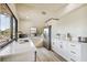 Modern kitchen with white cabinets, stainless steel appliances, and quartz countertops at 7147 La Lenaire Dr, Longboat Key, FL 34228
