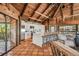 Modern white kitchen with stainless steel appliances and island seating at 7147 La Lenaire Dr, Longboat Key, FL 34228