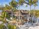 Waterfront property with expansive deck and lush landscaping at 7147 La Lenaire Dr, Longboat Key, FL 34228