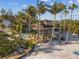 Elevated home on stilts with private beach access and tropical landscaping at 7147 La Lenaire Dr, Longboat Key, FL 34228