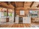 Relaxing common area with wood-beamed ceiling, tile floors, and a wet bar at 7147 La Lenaire Dr, Longboat Key, FL 34228