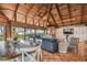 Open living space with vaulted ceilings, wood beams, and a dining area at 7147 La Lenaire Dr, Longboat Key, FL 34228