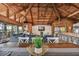 Open concept dining space with large wooden table and access to balcony at 7147 La Lenaire Dr, Longboat Key, FL 34228