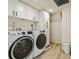 Bright laundry room with modern washer, dryer, and ample storage at 7147 La Lenaire Dr, Longboat Key, FL 34228