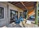 Relaxing covered deck with patio furniture, cornhole, and hot tub at 7147 La Lenaire Dr, Longboat Key, FL 34228