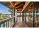 Covered lanai with tile flooring, seating area, and stunning water views at 7147 La Lenaire Dr, Longboat Key, FL 34228
