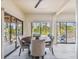 Casual dining area with round table and four chairs, sliders to deck and water views at 7147 La Lenaire Dr, Longboat Key, FL 34228