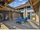 Spacious wooden deck with two blue Adirondack chairs and small table at 7147 La Lenaire Dr, Longboat Key, FL 34228