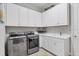 Laundry room with modern appliances and white cabinets at 4811 Cabreo Ct, Lakewood Ranch, FL 34211