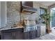 Upscale outdoor kitchen with stainless steel appliances and granite countertops at 4811 Cabreo Ct, Lakewood Ranch, FL 34211