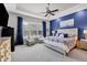 Large main bedroom with blue accent wall and comfortable seating at 4811 Cabreo Ct, Lakewood Ranch, FL 34211