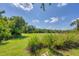 Spacious backyard with lush grass and mature trees at 4811 Cabreo Ct, Lakewood Ranch, FL 34211