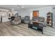 Relaxing living room with gray reclining furniture and wood-look floors at 220 Santa Maria St # 240, Venice, FL 34285