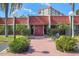 Attractive building entrance with red tile roof and landscaping at 220 Santa Maria St # 240, Venice, FL 34285