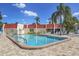 Refreshing community pool with patio chairs and umbrellas at 220 Santa Maria St # 240, Venice, FL 34285