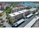Aerial view of condo building with parking and waterfront access at 220 Santa Maria St # 240, Venice, FL 34285