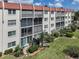 Condo building showcasing patio, landscaping, and building exterior at 220 Santa Maria St # 240, Venice, FL 34285