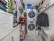 Convenient laundry room with washer, dryer, and storage shelves at 220 Santa Maria St # 240, Venice, FL 34285