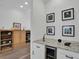 Built-in wet bar with granite countertop, wine cooler, and shelving at 4701 50Th W Ave, Bradenton, FL 34210