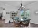Bright dining area with glass-top table and wicker chairs, view to backyard at 4701 50Th W Ave, Bradenton, FL 34210
