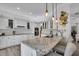 Spacious kitchen with white cabinets, granite countertops, and breakfast bar at 4701 50Th W Ave, Bradenton, FL 34210