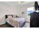 Bright bedroom with queen bed, large window, and ceiling fan at 4701 50Th W Ave, Bradenton, FL 34210