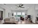 Spacious living room with comfy seating, large windows, and hardwood floors at 4701 50Th W Ave, Bradenton, FL 34210
