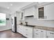 Kitchen with granite counters, white cabinets and gas cooktop at 4701 50Th W Ave, Bradenton, FL 34210