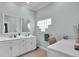 Elegant bathroom with double vanity, large mirror, and glass block window at 4701 50Th W Ave, Bradenton, FL 34210