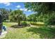 Backyard view with pond, palm trees, and lush landscaping at 4701 50Th W Ave, Bradenton, FL 34210