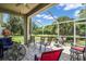 Spacious screened patio with outdoor furniture and grill, overlooking backyard at 4701 50Th W Ave, Bradenton, FL 34210