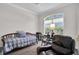 Bedroom with daybed, large window, and leather chair at 4701 50Th W Ave, Bradenton, FL 34210