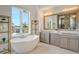 Elegant bathroom with double vanity and free-standing tub at 121 Seagull Ln, Sarasota, FL 34236