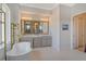 Bathroom with double vanity and free-standing tub at 121 Seagull Ln, Sarasota, FL 34236