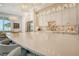 Large kitchen island with seating, white cabinets, and ocean views at 121 Seagull Ln, Sarasota, FL 34236