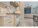Modern kitchen features white cabinetry and a professional range at 121 Seagull Ln, Sarasota, FL 34236